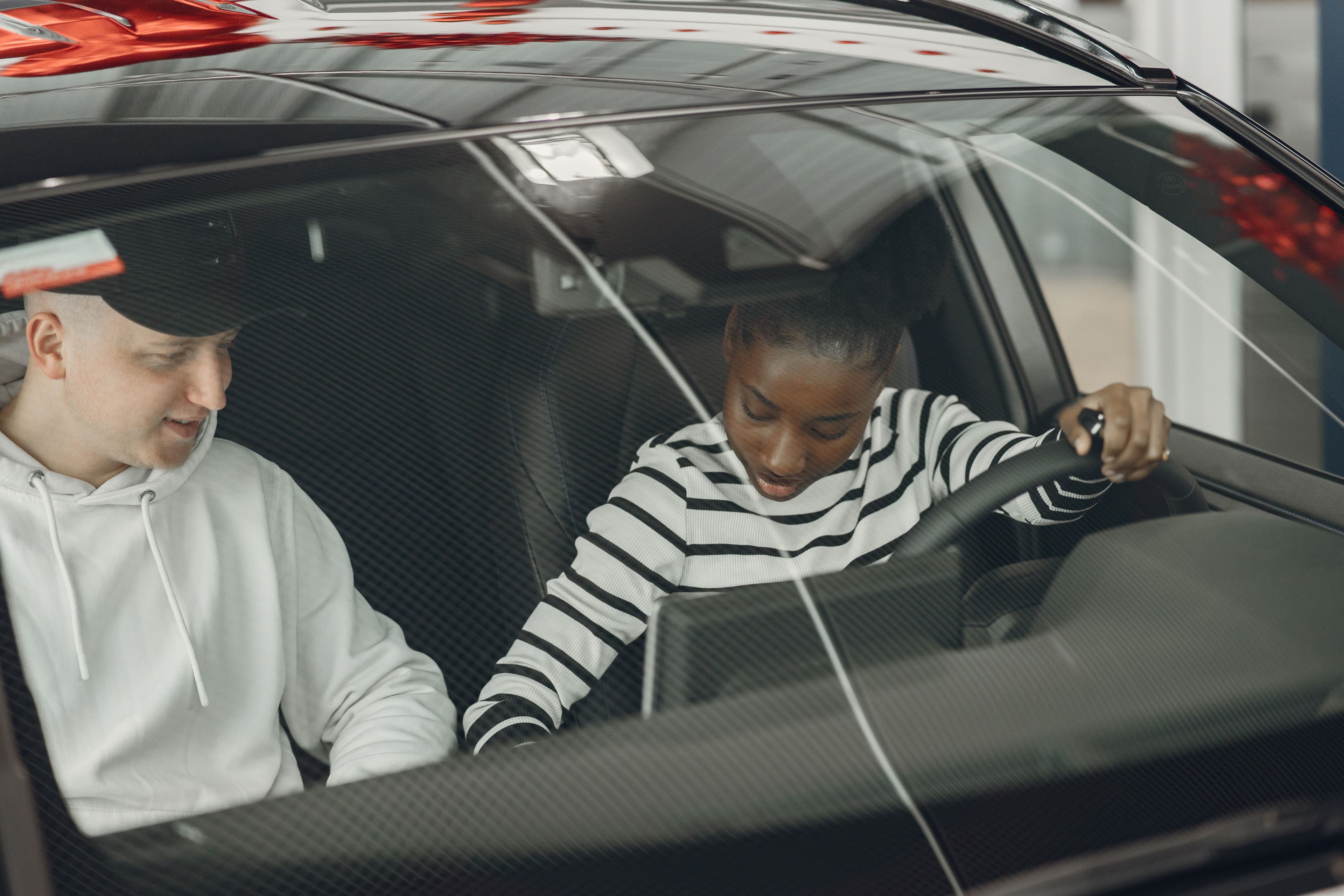 Driving instructor guiding a student during a lesson